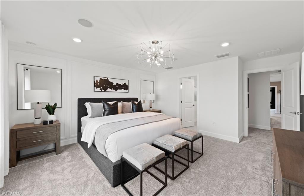 1879 Mesa Lane Naples, FL 34120 - Photo 15 of 24 a bedroom with a bed and a chandelier