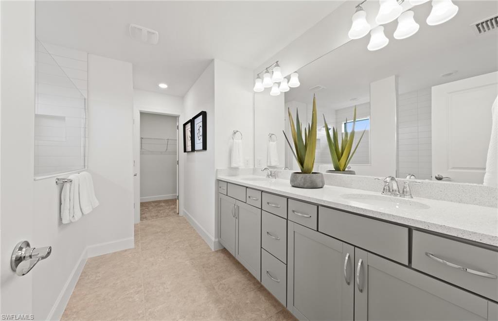 1879 Mesa Lane Naples, FL 34120 - Photo 17 of 24 a bathroom with a double vanity sink and a mirror