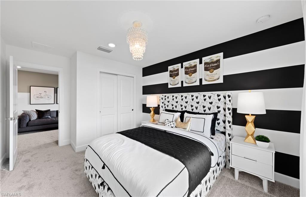 1879 Mesa Lane Naples, FL 34120 - Photo 20 of 24 a bedroom with a bed and a view of en suite bathroom