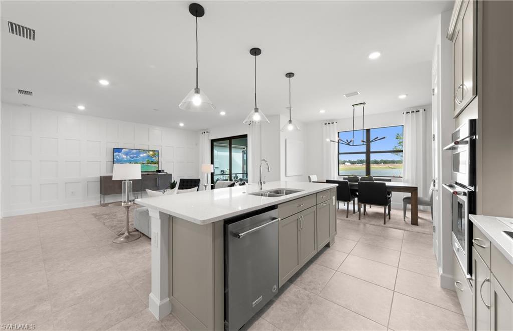 1879 Mesa Lane Naples, FL 34120 - Photo 5 of 24 a kitchen with kitchen island a sink table and chairs