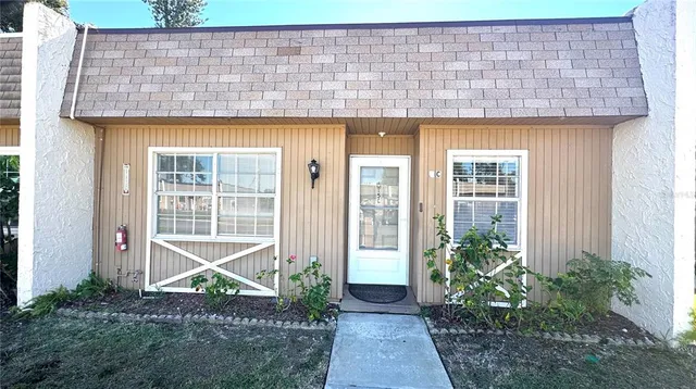 a front view of a house with plants