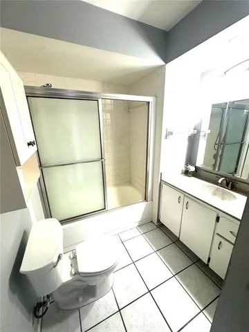 a bathroom with a mirror and a shower