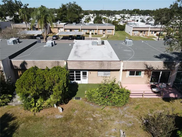 an aerial view of multiple houses with yard