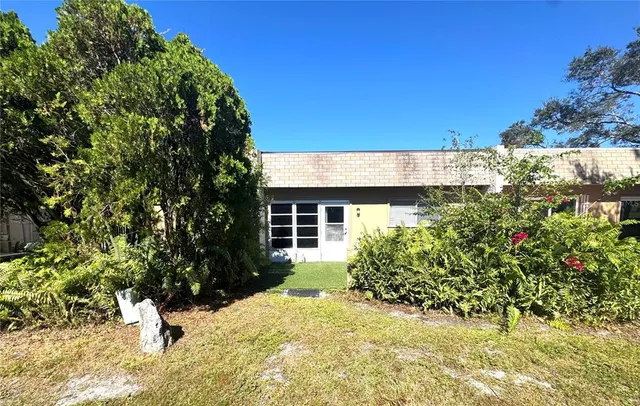 a view of a house with a tree in the background