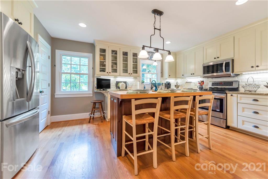 404 Dameron Road Bessemer City, NC 28016 - Photo 21 of 47 a kitchen with stainless steel appliances a dining table chairs stove and refrigerator
