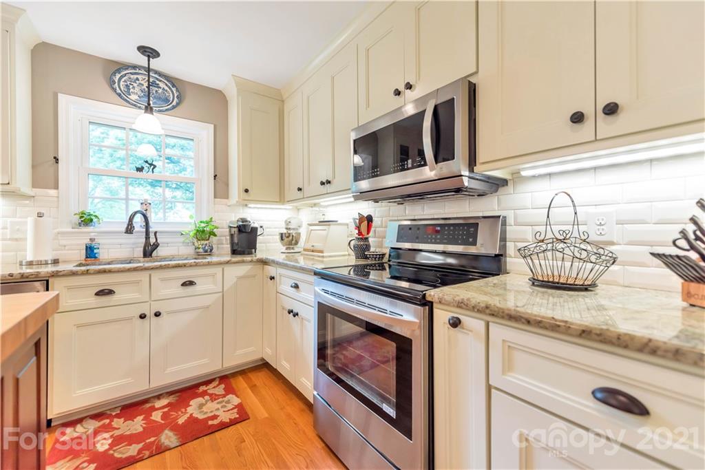 404 Dameron Road Bessemer City, NC 28016 - Photo 23 of 47 a kitchen with stainless steel appliances granite countertop white cabinets and window