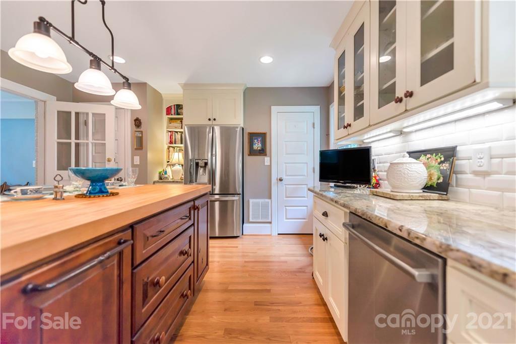 404 Dameron Road Bessemer City, NC 28016 - Photo 25 of 47 a large kitchen with stainless steel appliances kitchen island granite countertop a sink and cabinets