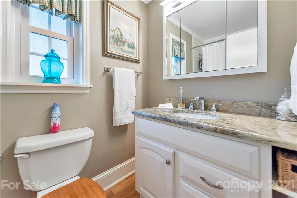 404 Dameron Road Bessemer City, NC 28016 - Photo 33 of 47 a bathroom with a granite countertop toilet sink and mirror