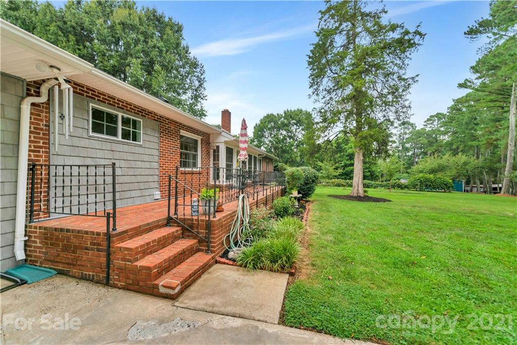 404 Dameron Road Bessemer City, NC 28016 - Photo 45 of 47 a backyard of a house with potted plants and large tree