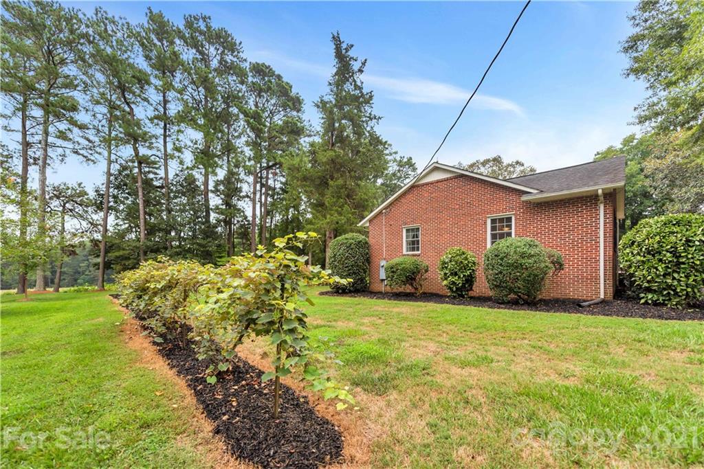 404 Dameron Road Bessemer City, NC 28016 - Photo 46 of 47 a yellow house with trees in front of it