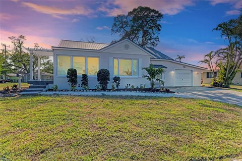 a view of a house with swimming pool and a yard