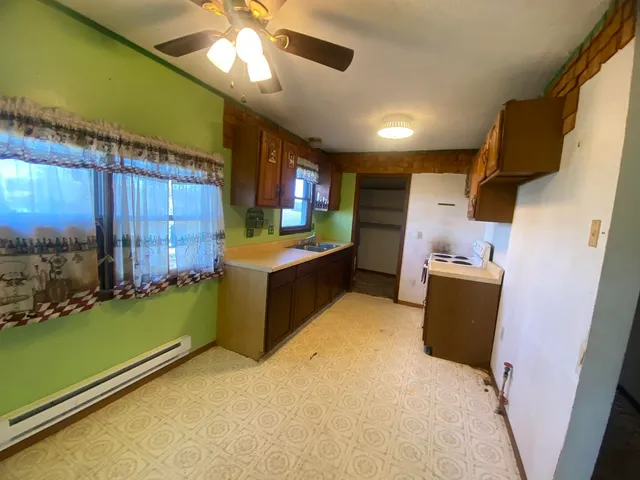 a view of a kitchen with a sink and cabinets