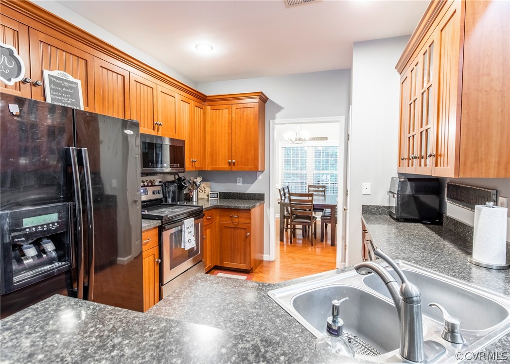 529 Brandywine Road Manquin, VA 23106 - Photo 15 of 50 a kitchen with stainless steel appliances granite countertop a refrigerator a sink a stove and blue cabinets with wooden floor