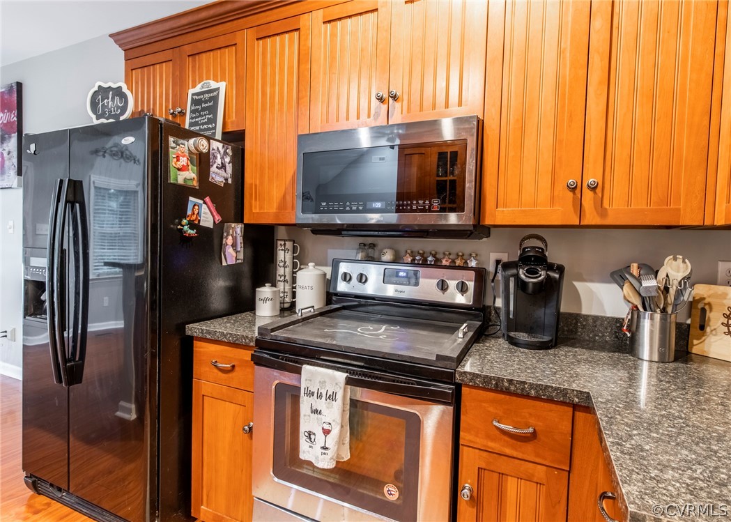 529 Brandywine Road Manquin, VA 23106 - Photo 16 of 50 a kitchen with stainless steel appliances granite countertop a refrigerator a stove and a sink with wooden floor