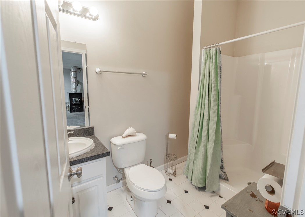 529 Brandywine Road Manquin, VA 23106 - Photo 41 of 50 a white toilet sitting next to a bathroom sink and a shower