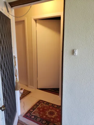 a view of a livingroom with furniture and floor to ceiling window