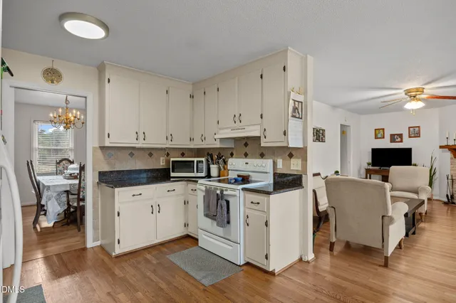 a kitchen with stainless steel appliances and white cabinets