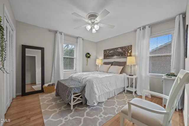 a bedroom with a large bed and a chandelier