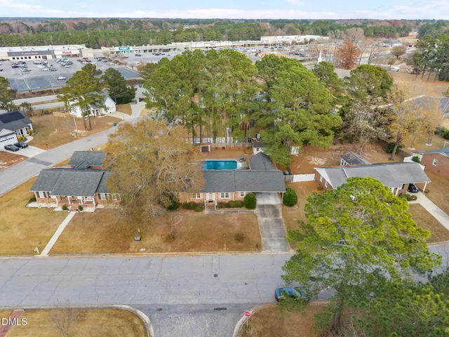 an aerial view of residential houses with outdoor space