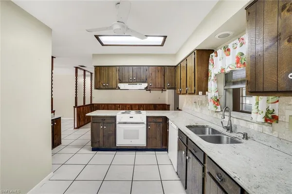 a kitchen with a stove sink and cabinets