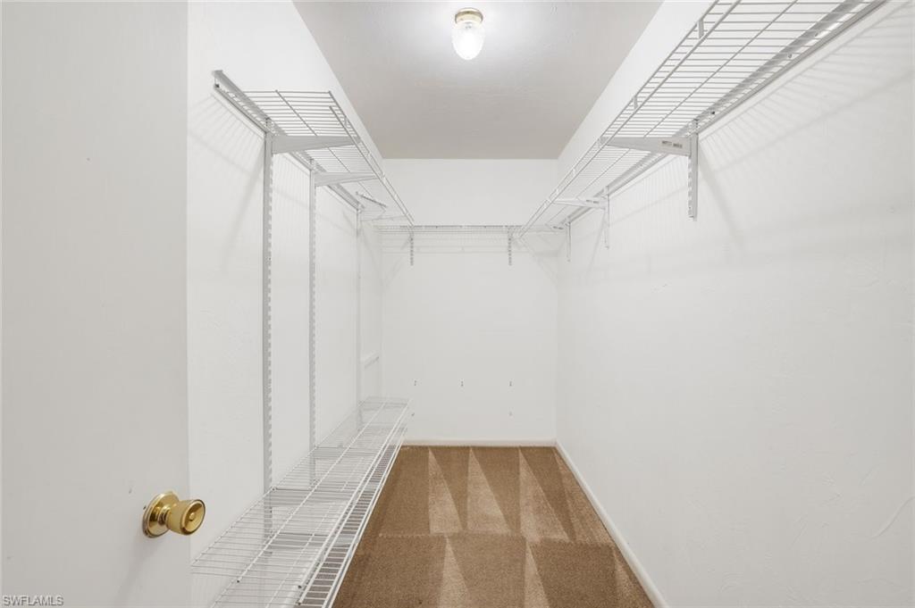 5290 Cypress Lane Naples, FL 34113 - Photo 16 of 35 a view of a room with wooden floor