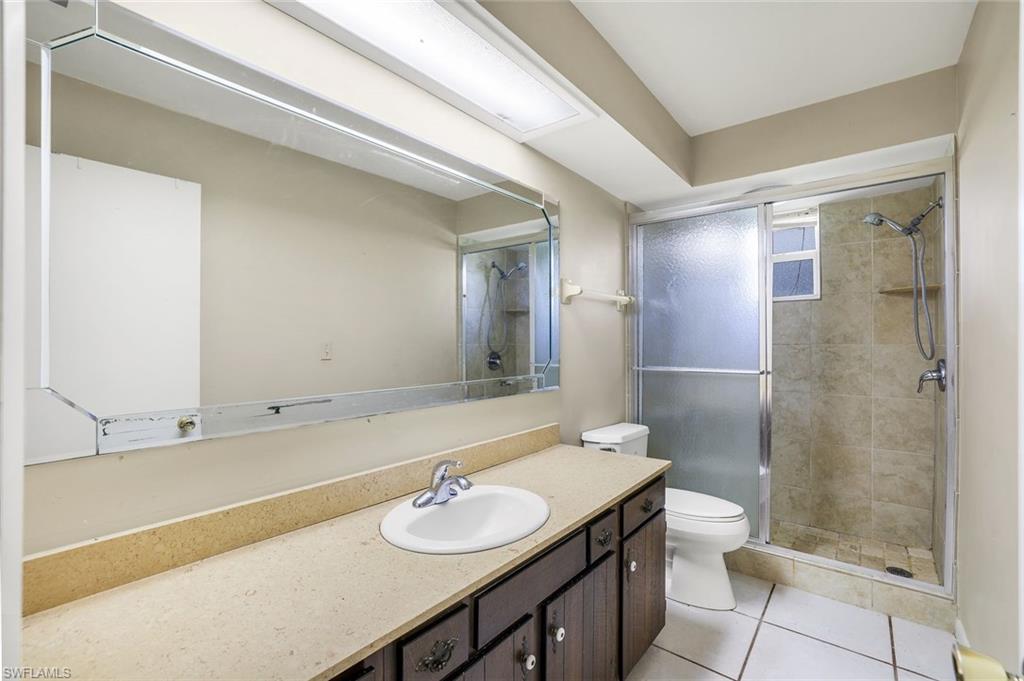 5290 Cypress Lane Naples, FL 34113 - Photo 17 of 35 a bathroom with a sink and a mirror