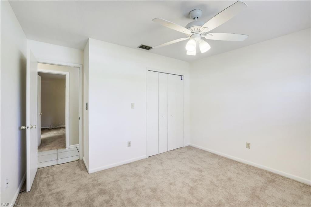 5290 Cypress Lane Naples, FL 34113 - Photo 19 of 35 an empty room with fan and ceiling fan