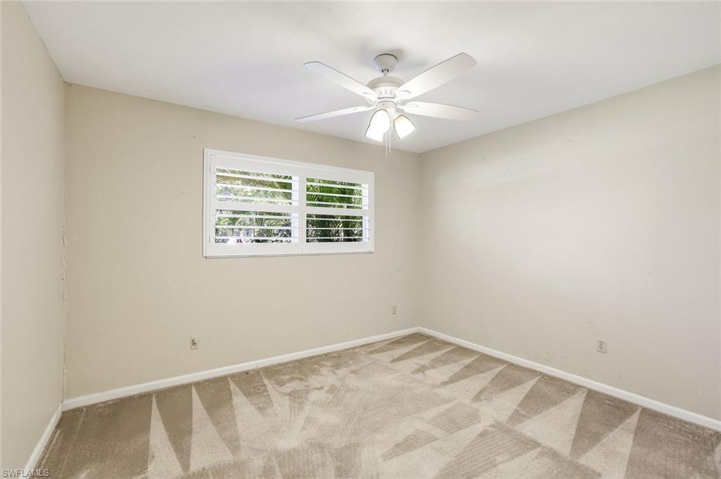 5290 Cypress Lane Naples, FL 34113 - Photo 21 of 35 a view of an empty room with a window