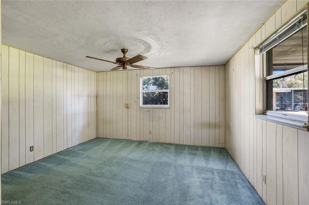 5290 Cypress Lane Naples, FL 34113 - Photo 22 of 35 an empty room with windows and fan