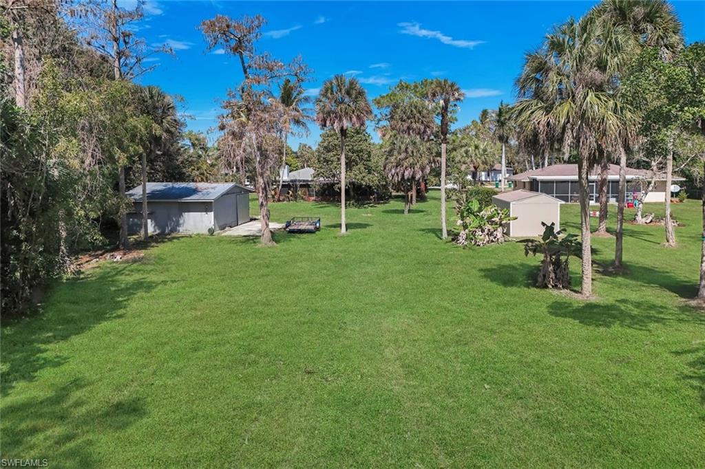 5290 Cypress Lane Naples, FL 34113 - Photo 27 of 35 a view of a garden with a house