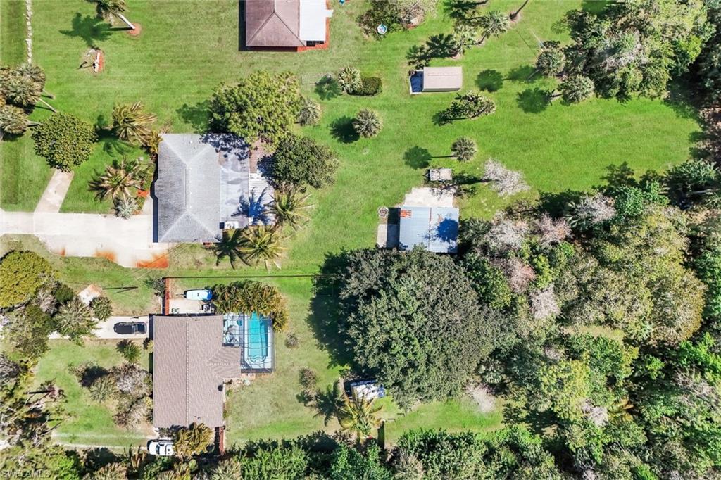 5290 Cypress Lane Naples, FL 34113 - Photo 33 of 35 an aerial view of a house with a yard and lake view
