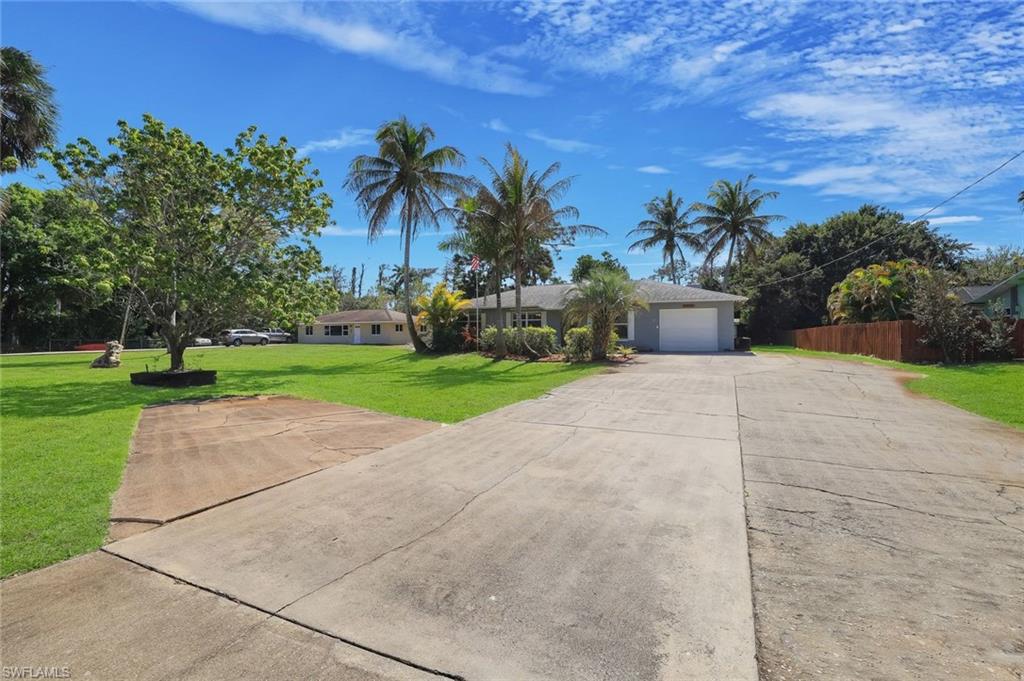 5290 Cypress Lane Naples, FL 34113 - Photo 34 of 35 a road view with a garden