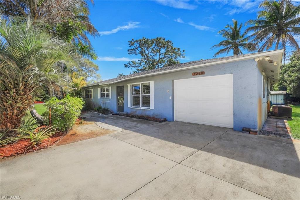 5290 Cypress Lane Naples, FL 34113 - Photo 4 of 35 a view of a house with a yard and plant