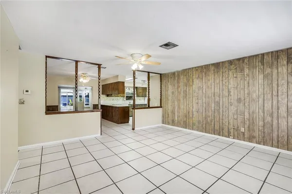 a kitchen with stainless steel appliances kitchen island granite countertop a refrigerator and cabinets