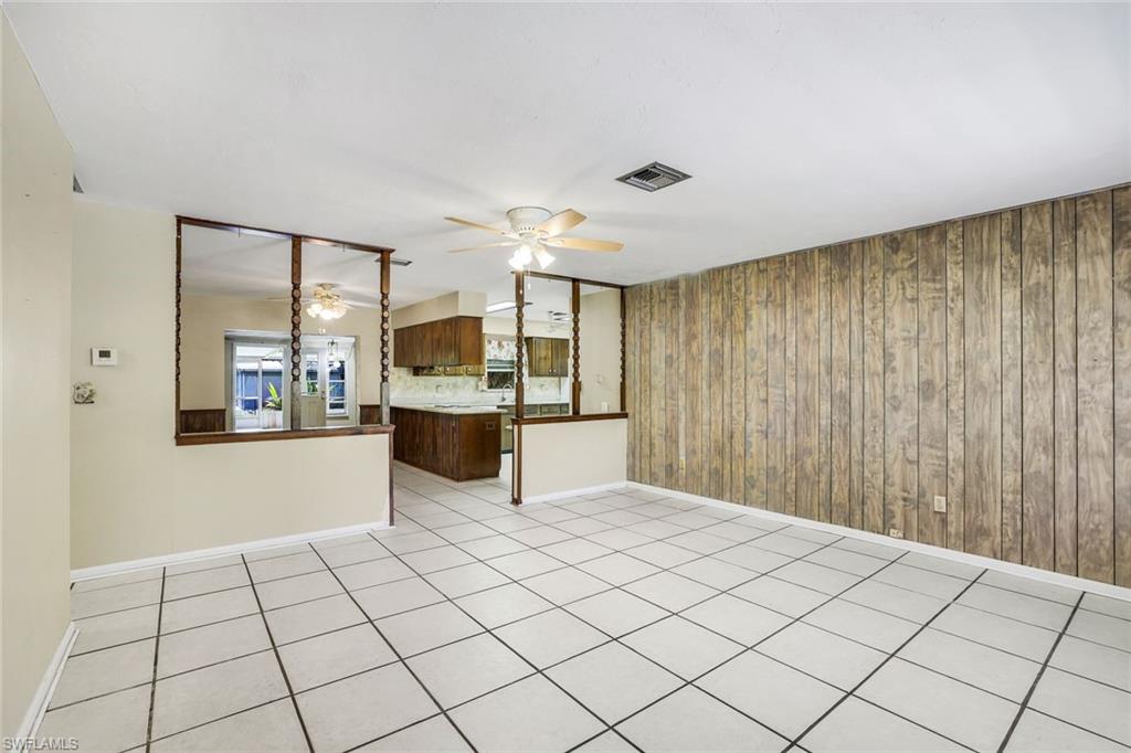 5290 Cypress Lane Naples, FL 34113 - Photo 7 of 35 a kitchen with stainless steel appliances kitchen island granite countertop a refrigerator and cabinets