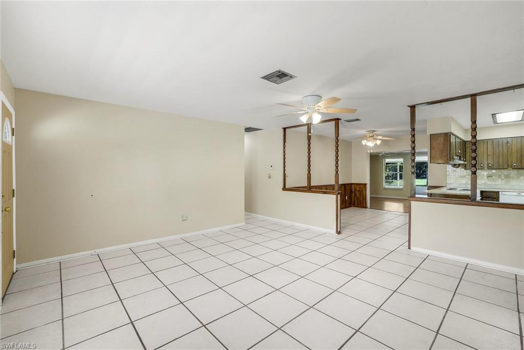5290 Cypress Lane Naples, FL 34113 - Photo 8 of 35 a view of a kitchen with kitchen island granite countertop a refrigerator and a stove top oven