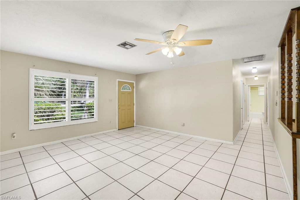 5290 Cypress Lane Naples, FL 34113 - Photo 9 of 35 a view of an empty room and window