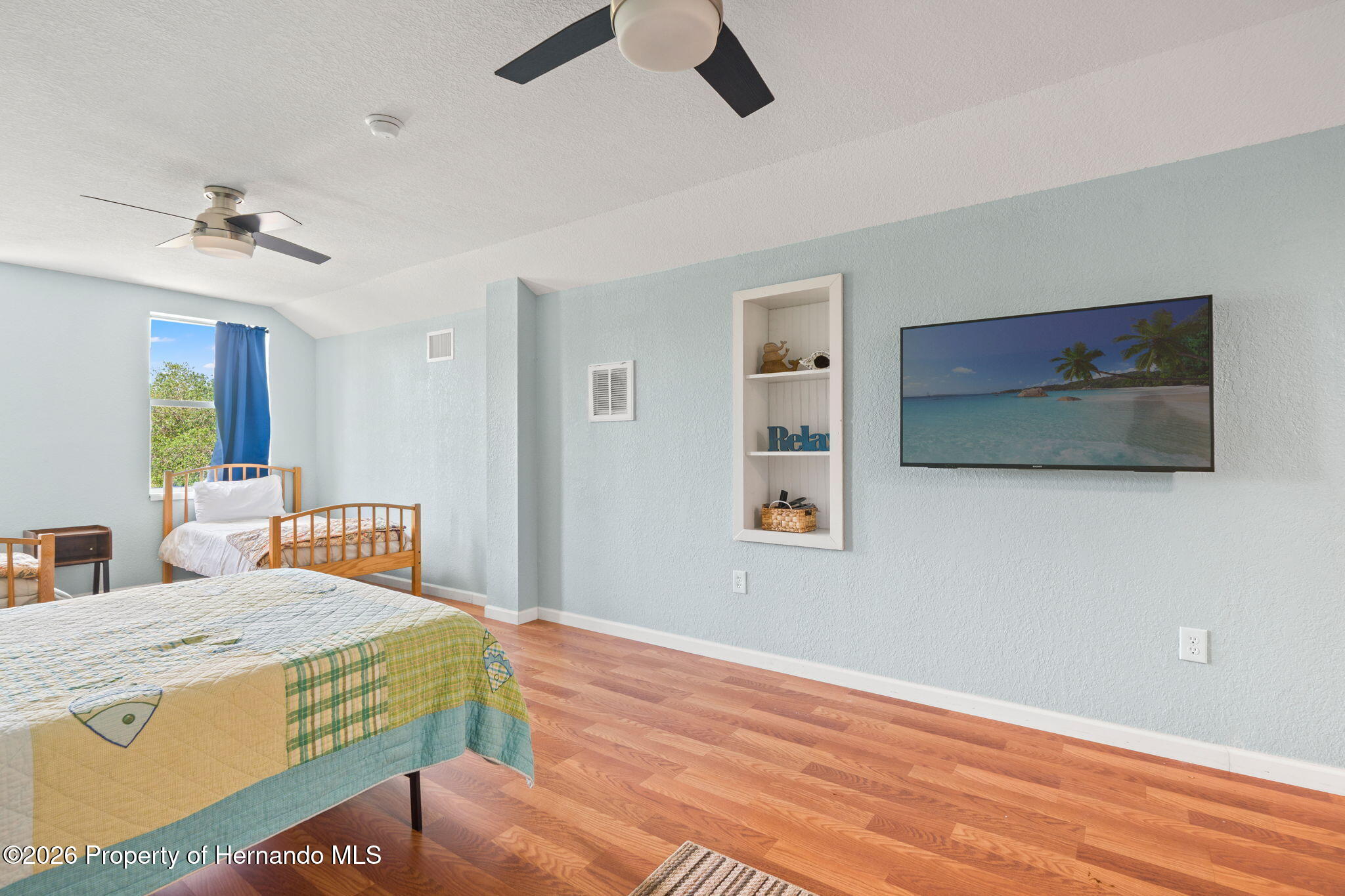 1566 Indian Bay Road Spring Hill, FL 34607 - Photo 38 of 56 a bedroom with a bed and a flat screen tv