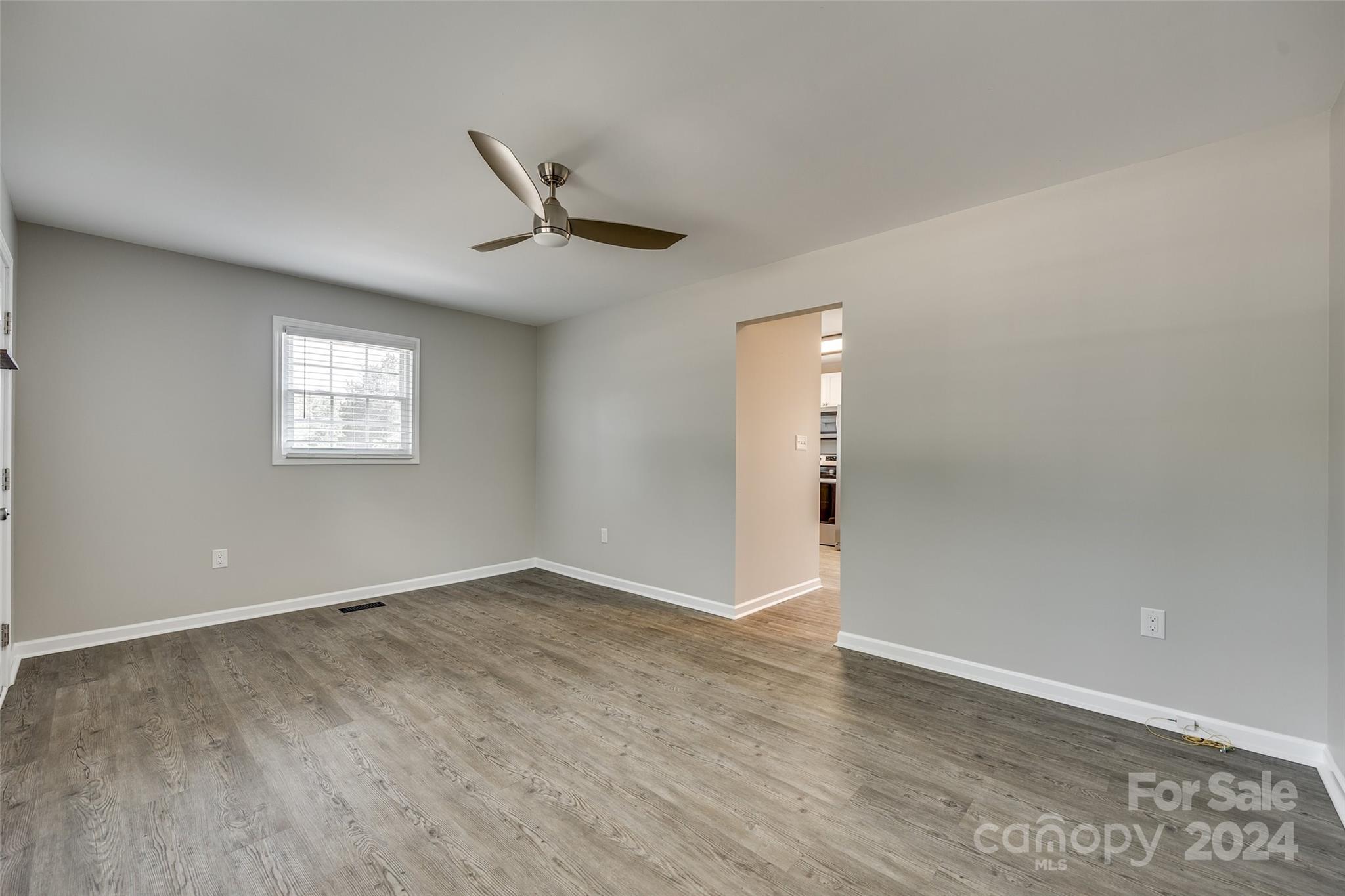 493 South Beersheba Road Clover, SC 29710 - Photo 11 of 25 an empty room with wooden floor fan and windows