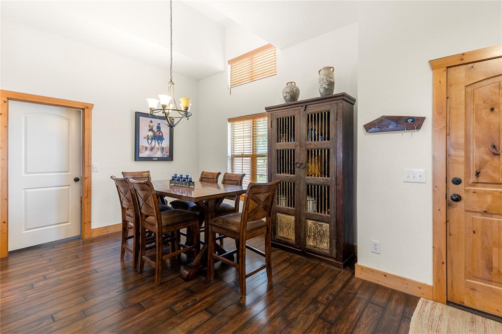 777 Stiles Road Whitesboro, TX 76273 - Photo 10 of 37 a view of a dining room with furniture and wooden floor