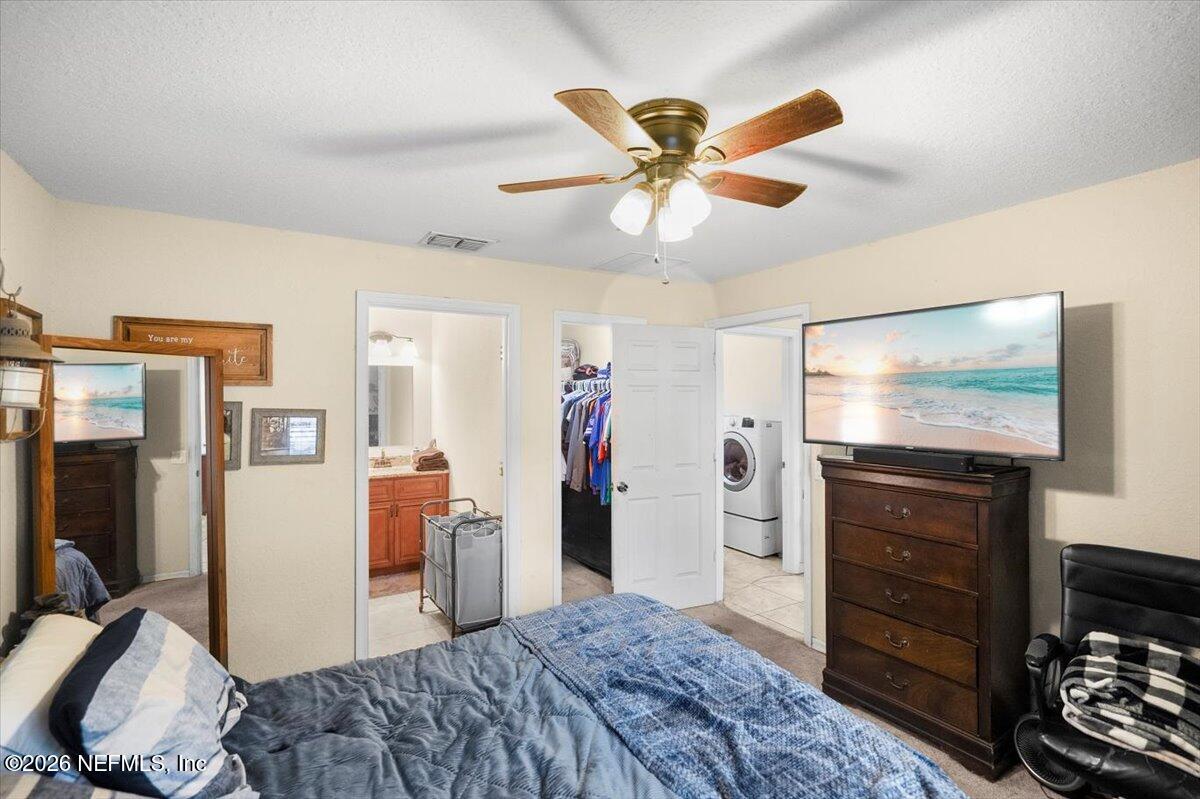 18 Pine Track Terrace Ocala, FL 34472 - Photo 13 of 23 a bedroom with a bed and a flat screen tv