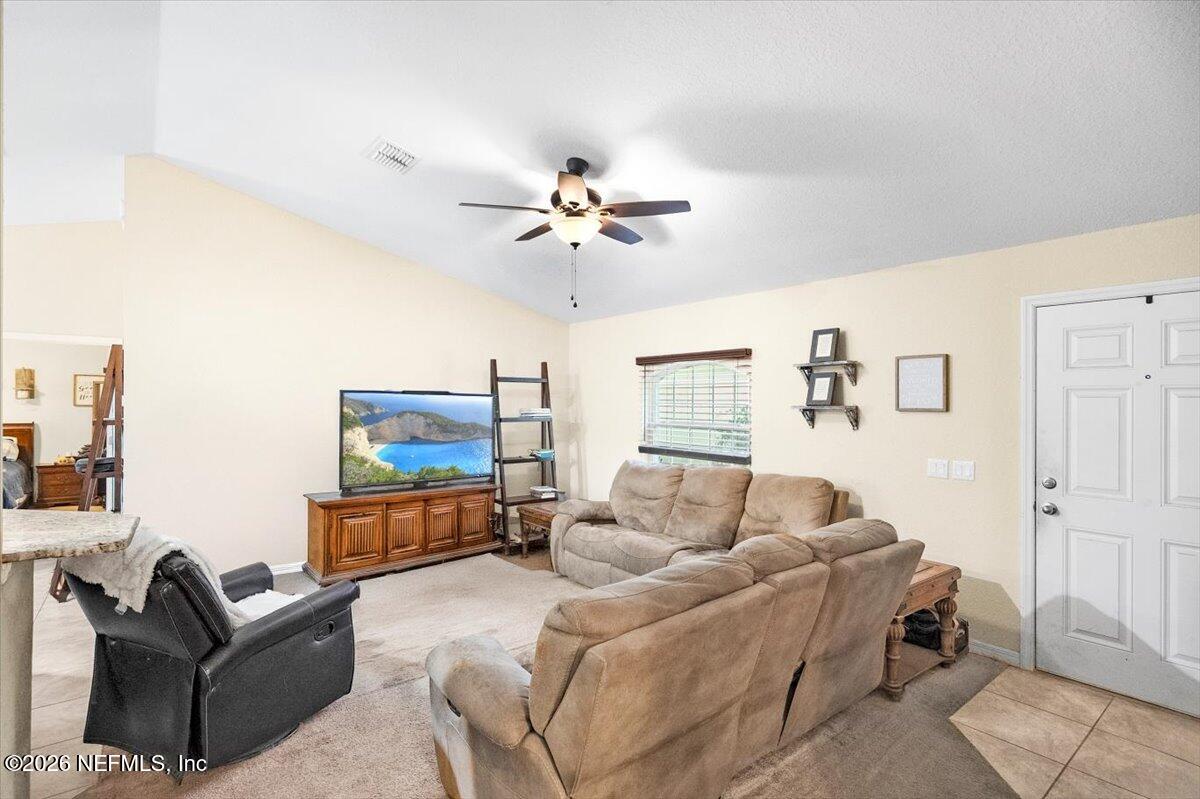 18 Pine Track Terrace Ocala, FL 34472 - Photo 3 of 23 a living room with furniture and a chandelier