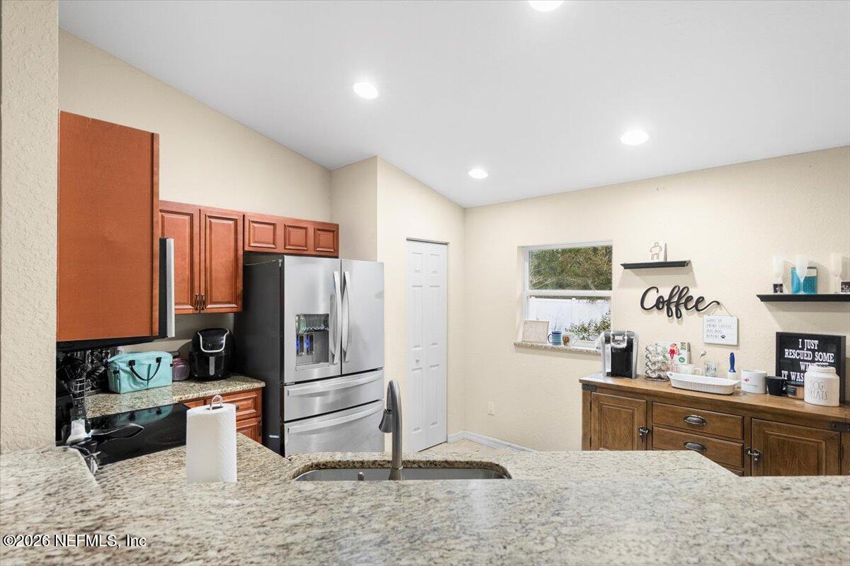 18 Pine Track Terrace Ocala, FL 34472 - Photo 7 of 23 a kitchen with stainless steel appliances wooden cabinets a refrigerator and a sink