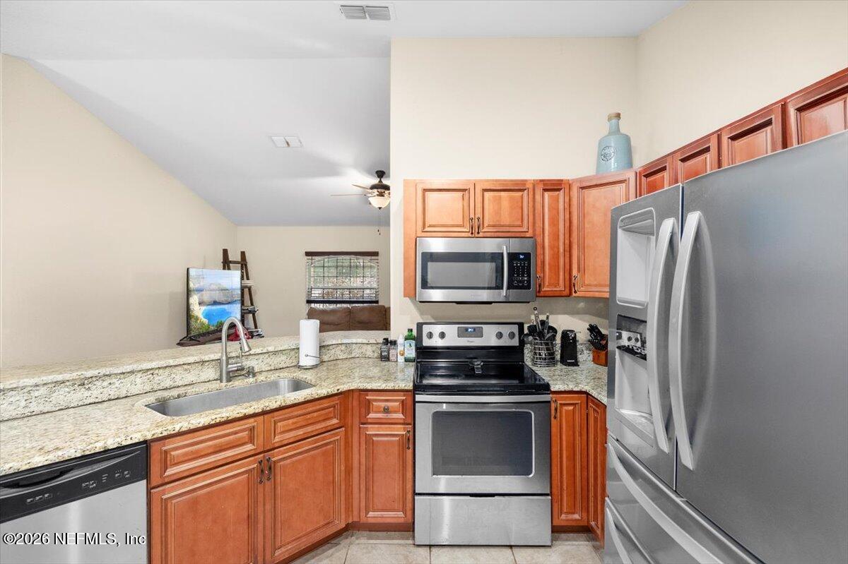 18 Pine Track Terrace Ocala, FL 34472 - Photo 8 of 23 a kitchen with stainless steel appliances a refrigerator sink and microwave