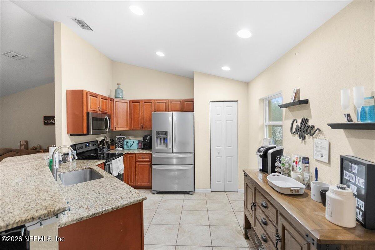 18 Pine Track Terrace Ocala, FL 34472 - Photo 9 of 23 a kitchen with granite countertop lots of counter top space and appliances