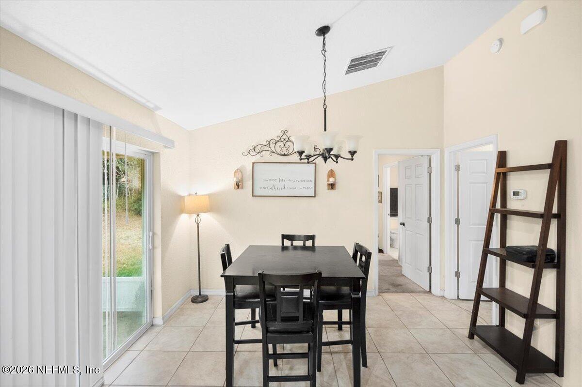 18 Pine Track Terrace Ocala, FL 34472 - Photo 10 of 23 a view of a dining room with furniture and a chandelier
