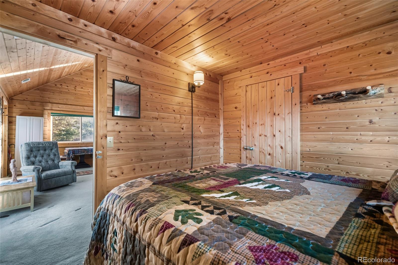 753 Teton Trail Como, CO 80456 - Photo 14 of 32 a bed sitting in a spacious bedroom next to a window