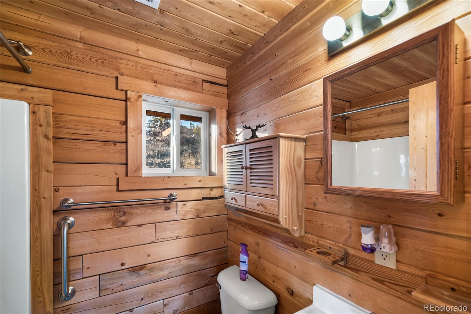 753 Teton Trail Como, CO 80456 - Photo 20 of 32 a bathroom with a sink and a window