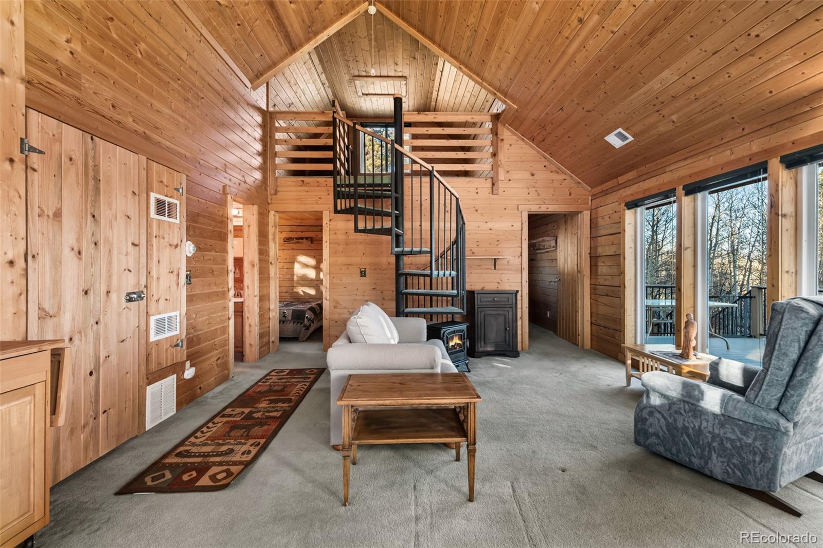 753 Teton Trail Como, CO 80456 - Photo 2 of 32 a bedroom with furniture and a floor to ceiling window