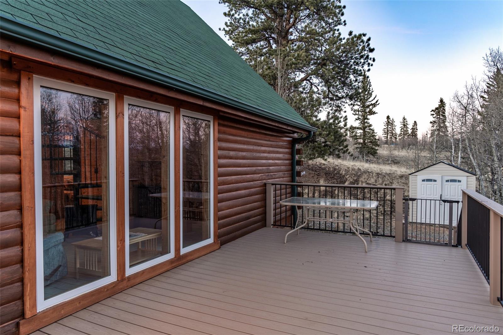 753 Teton Trail Como, CO 80456 - Photo 23 of 32 a view of a house with a large window and wooden fence